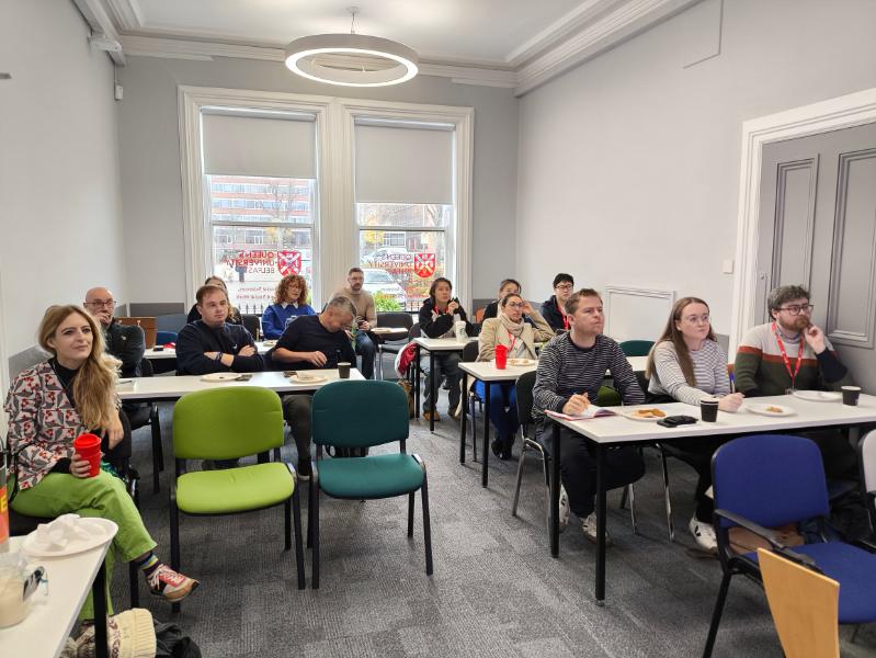 Picture of students and staff listening to a presentation